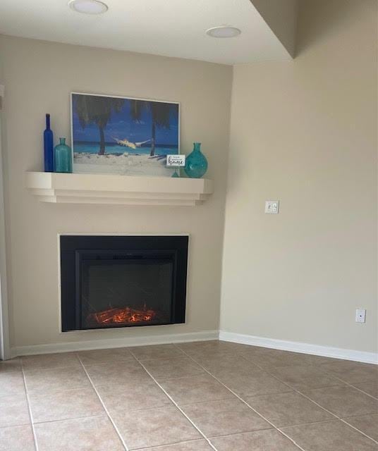 6735 Tidewater Dr, Navarre, FL 32566 - detailed view of a lit fireplace and baseboards