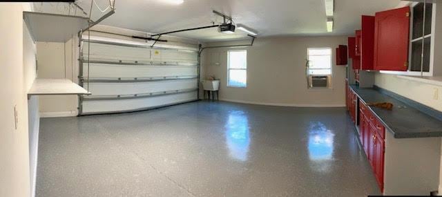 6735 Tidewater Dr, Navarre, FL 32566 - garage featuring a garage door opener, baseboards, and cooling unit