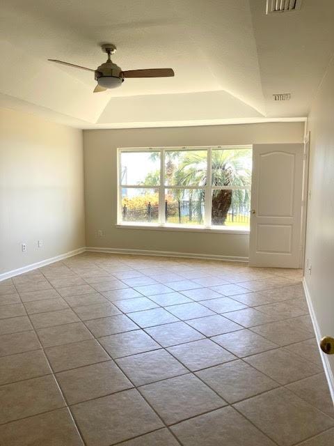 6735 Tidewater Dr, Navarre, FL 32566 - spare room with a tray ceiling, plenty of natural light, ceiling fan, and baseboards