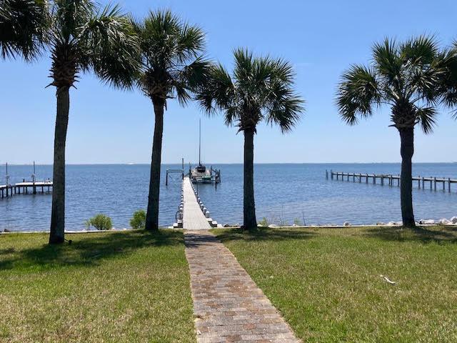 6735 Tidewater Dr, Navarre, FL 32566 - dock featuring a yard and a water view