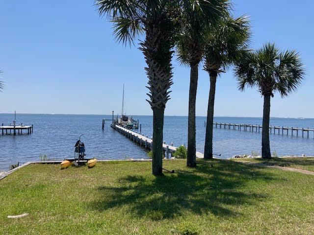 6735 Tidewater Dr, Navarre, FL 32566 - dock with a water view and a lawn