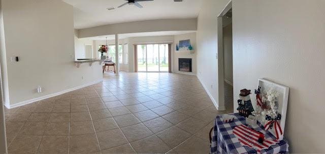6735 Tidewater Dr, Navarre, FL 32566 - unfurnished living room featuring tile patterned floors, baseboards, and a fireplace