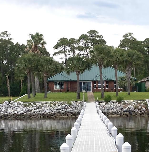 6735 Tidewater Dr, Navarre, FL 32566 - dock area with a water view and a yard