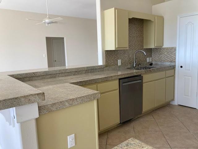 6735 Tidewater Dr, Navarre, FL 32566 - kitchen featuring dishwasher, a sink, cream cabinets, and light tile patterned floors