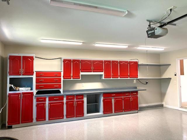 6735 Tidewater Dr, Navarre, FL 32566 - kitchen featuring open shelves, baseboards, and dark countertops