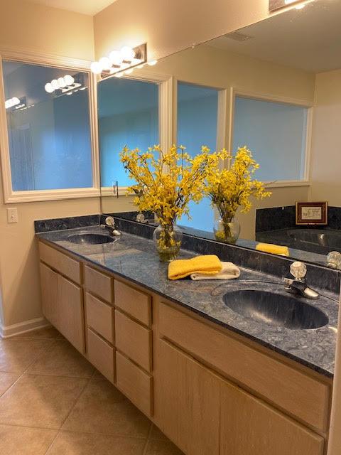 6735 Tidewater Dr, Navarre, FL 32566 - bathroom with double vanity, tile patterned flooring, and baseboards