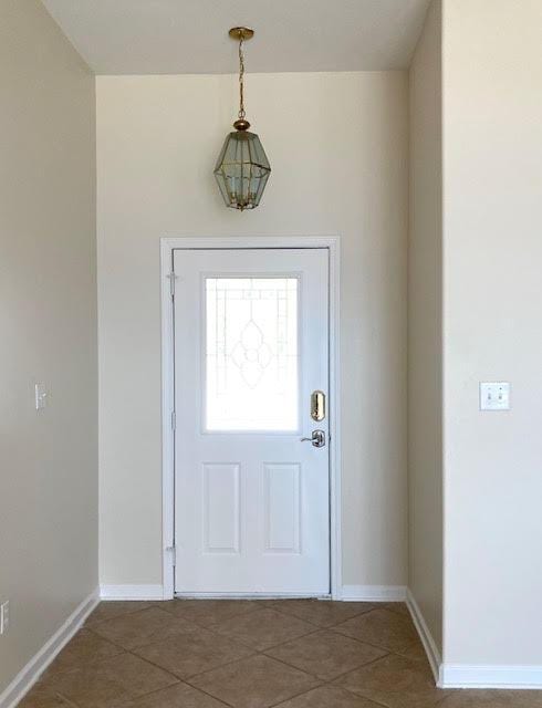 6735 Tidewater Dr, Navarre, FL 32566 - foyer entrance with baseboards and tile patterned floors