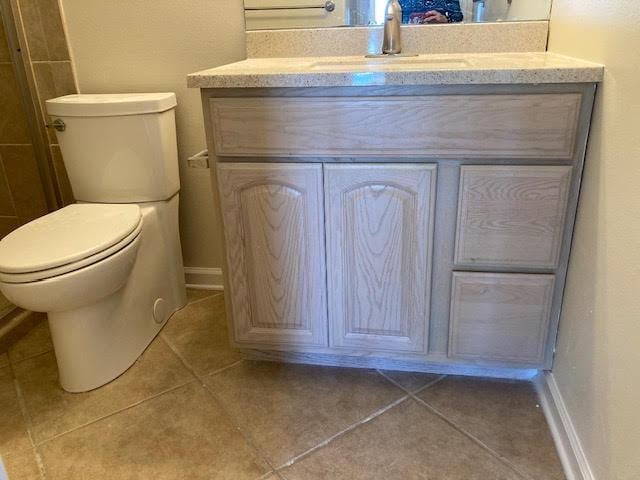 6735 Tidewater Dr, Navarre, FL 32566 - bathroom with vanity, tile patterned floors, toilet, and baseboards