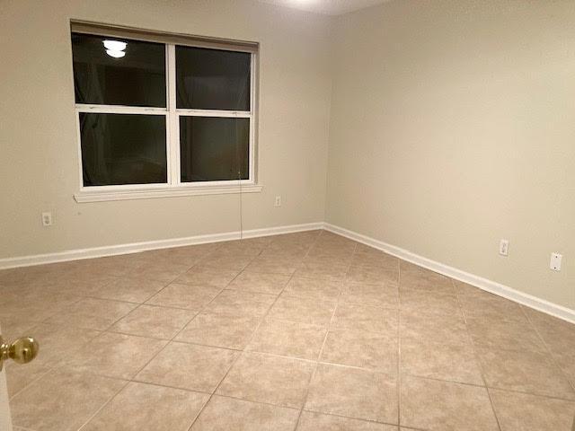6735 Tidewater Dr, Navarre, FL 32566 - unfurnished room featuring light tile patterned floors and baseboards