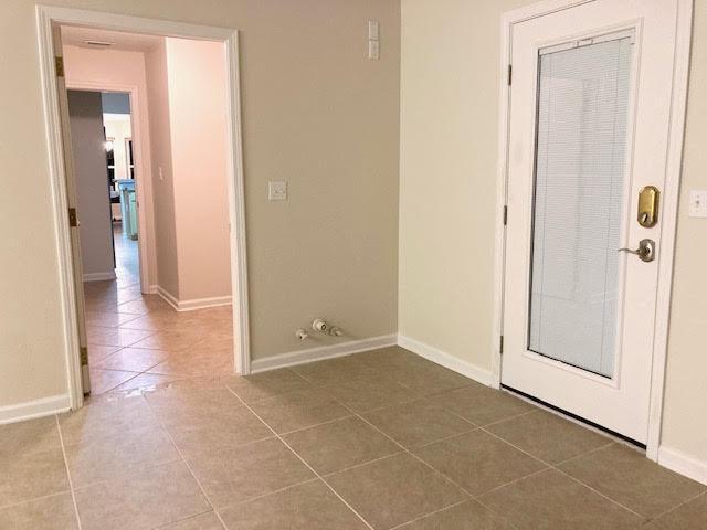 6735 Tidewater Dr, Navarre, FL 32566 - foyer with tile patterned floors and baseboards