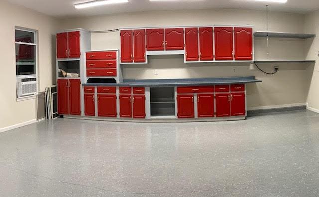 6735 Tidewater Dr, Navarre, FL 32566 - kitchen with red cabinets, baseboards, open shelves, and cooling unit