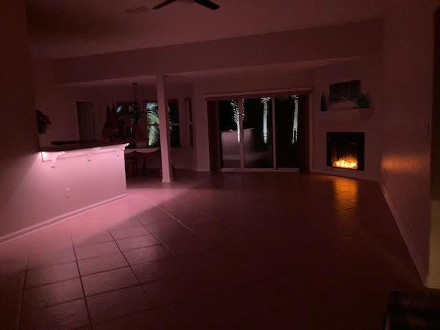 6735 Tidewater Dr, Navarre, FL 32566 - view of patio featuring ceiling fan and a lit fireplace