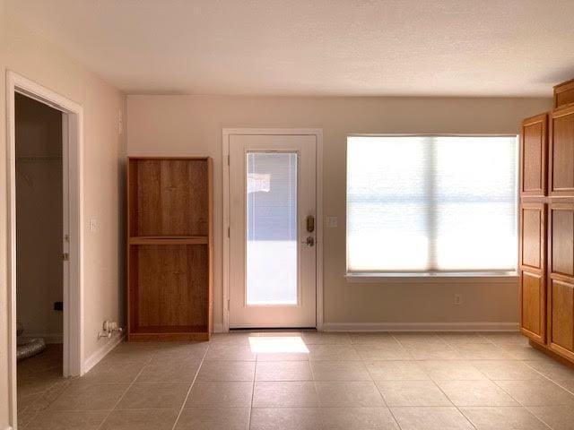 6735 Tidewater Dr, Navarre, FL 32566 - entryway with baseboards and light tile patterned flooring