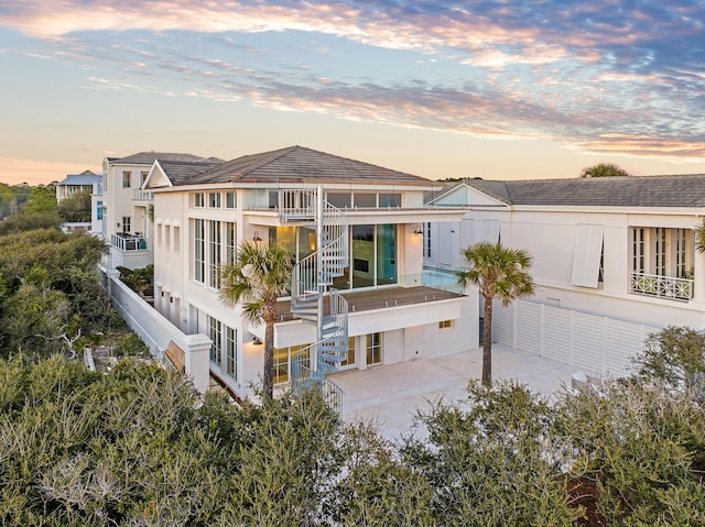 40 Jasmine Cir, Santa Rosa Beach, FL 32459 - rear view of house with stairs, stucco siding, and a balcony