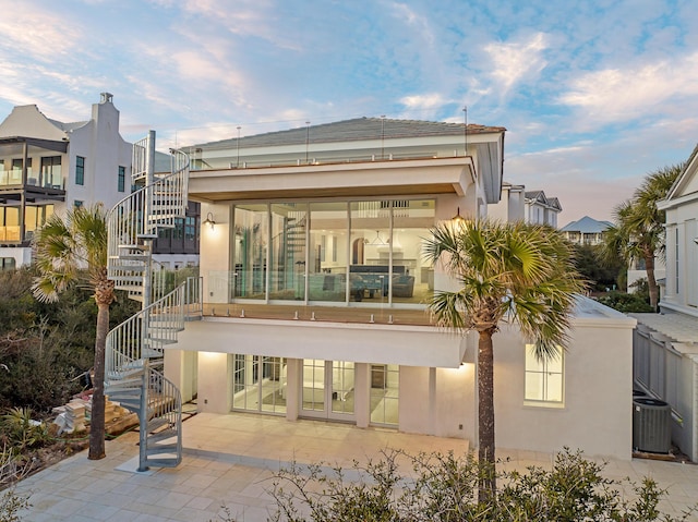 40 Jasmine Cir, Santa Rosa Beach, FL 32459 - rear view of house with stairway, central air condition unit, stucco siding, and a patio