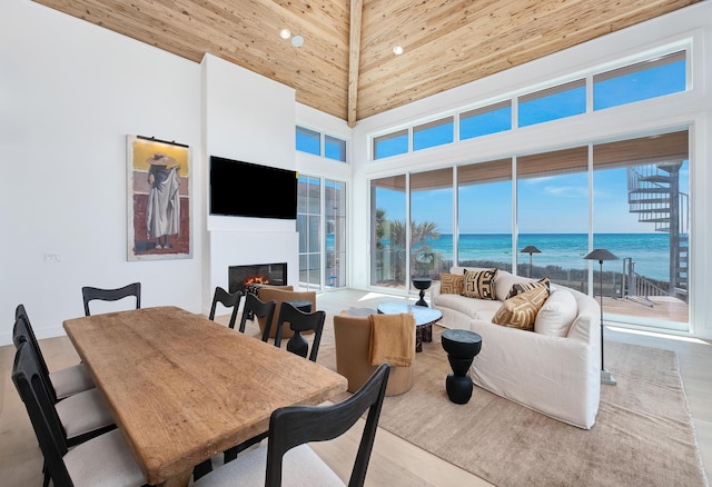 40 Jasmine Cir, Santa Rosa Beach, FL 32459 - living area featuring wood finished floors, a warm lit fireplace, a towering ceiling, and recessed lighting