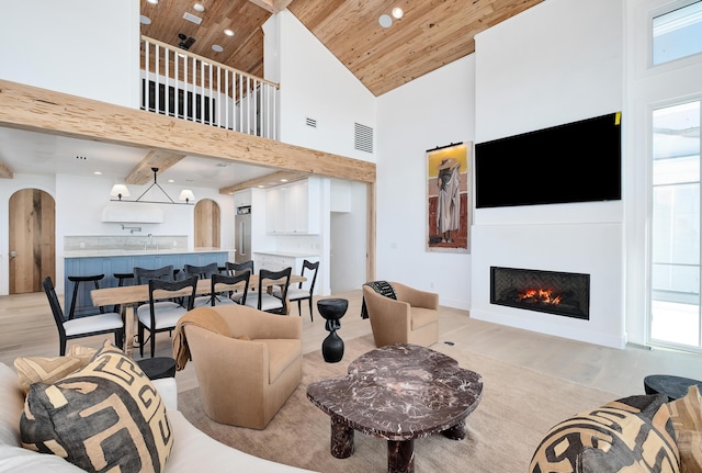 40 Jasmine Cir, Santa Rosa Beach, FL 32459 - living area with arched walkways, wooden ceiling, high vaulted ceiling, recessed lighting, and a warm lit fireplace