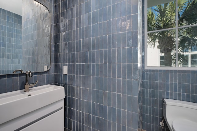 40 Jasmine Cir, Santa Rosa Beach, FL 32459 - half bathroom featuring tile walls, healthy amount of natural light, vanity, and toilet