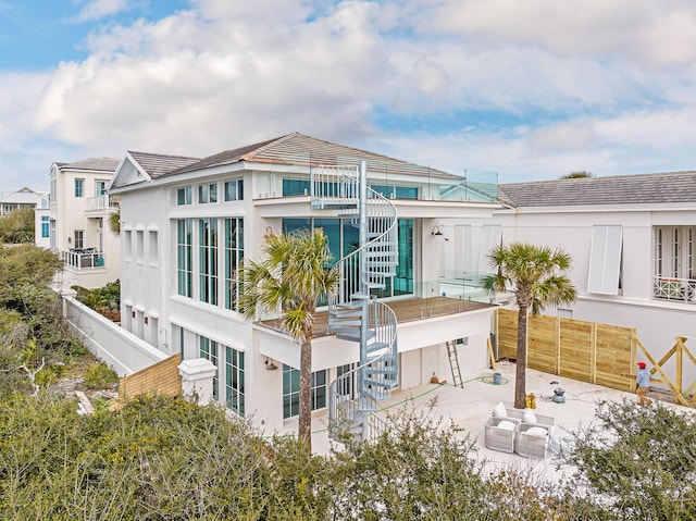 40 Jasmine Cir, Santa Rosa Beach, FL 32459 - rear view of property with stairway and stucco siding