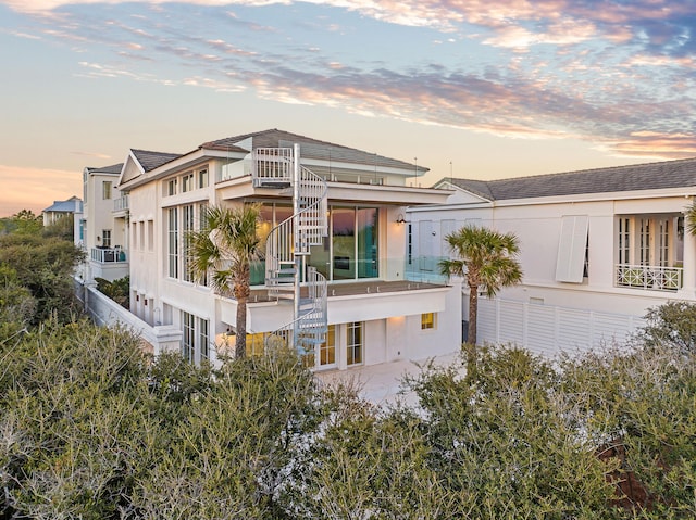 40 Jasmine Cir, Santa Rosa Beach, FL 32459 - view of front facade with stucco siding, stairway, and a balcony
