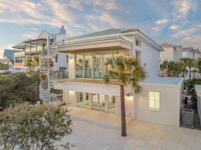 40 Jasmine Cir, Santa Rosa Beach, FL 32459 - rear view of house featuring stairway, cooling unit, stucco siding, and a patio area