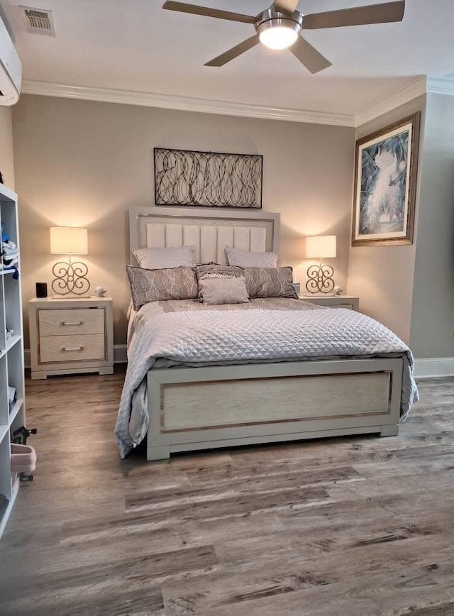 4134 Cobalt Cir Unit Ro14, Panama City, FL 32408 - bedroom featuring ornamental molding, wood finished floors, an AC wall unit, ceiling fan, and baseboards
