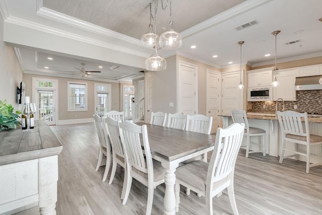 4134 Cobalt Cir Unit Ro14, Panama City, FL 32408 - dining room featuring a tray ceiling, light wood-type flooring, crown molding, ceiling fan, and recessed lighting
