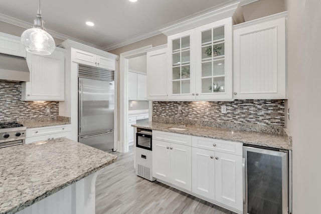 4134 Cobalt Cir Unit Ro14, Panama City, FL 32408 - kitchen featuring wine cooler, high end appliances, white cabinetry, crown molding, and glass insert cabinets