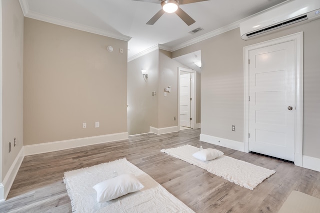 4134 Cobalt Cir Unit Ro14, Panama City, FL 32408 - bedroom featuring an AC wall unit, crown molding, light wood-style flooring, baseboards, and ceiling fan