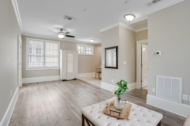 4134 Cobalt Cir Unit Ro14, Panama City, FL 32408 - living room featuring crown molding, light wood-style flooring, a ceiling fan, and baseboards