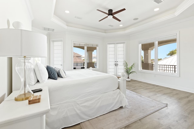 52 Tranquility Ln, Destin, FL 32541 - bedroom with a raised ceiling, access to exterior, light wood finished floors, ornamental molding, and baseboards