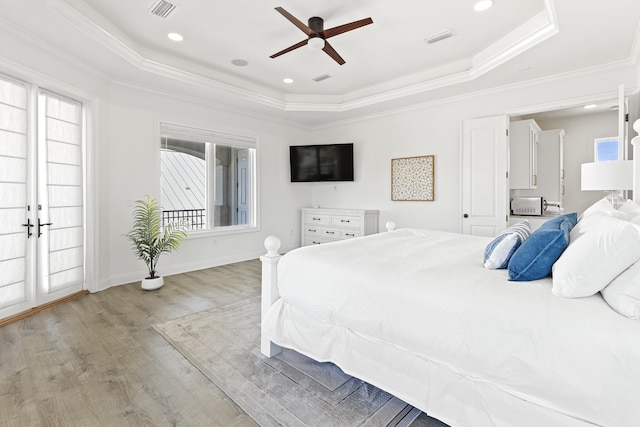 52 Tranquility Ln, Destin, FL 32541 - bedroom with a tray ceiling, wood finished floors, ornamental molding, baseboards, and a ceiling fan