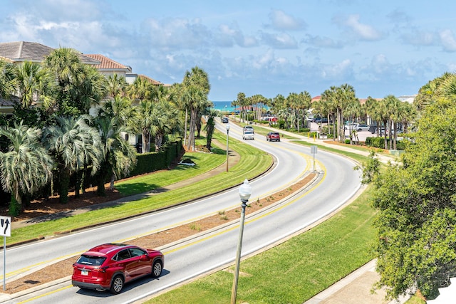52 Tranquility Ln, Destin, FL 32541 - view of asphalt road featuring sidewalks, curbs, traffic signs, and street lighting