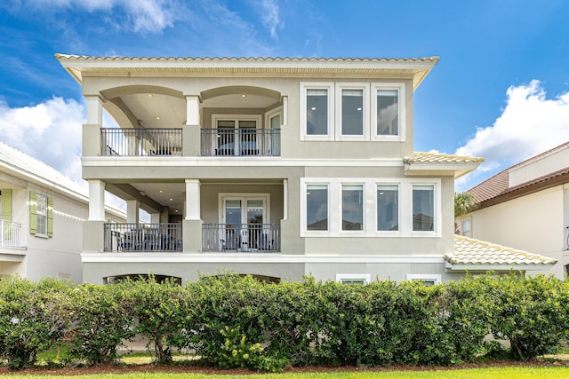 52 Tranquility Ln, Destin, FL 32541 - rear view of property featuring a balcony and stucco siding