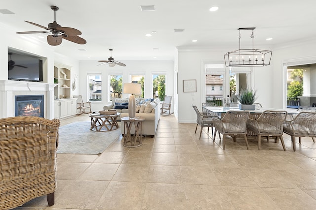 52 Tranquility Ln, Destin, FL 32541 - dining space featuring ornamental molding, a glass covered fireplace, a ceiling fan, recessed lighting, and baseboards