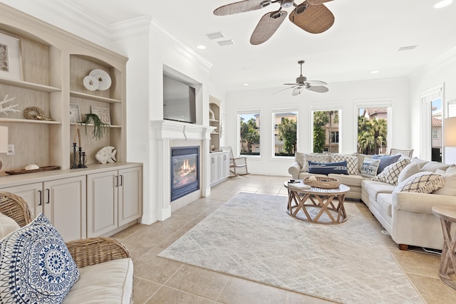 52 Tranquility Ln, Destin, FL 32541 - living area featuring a ceiling fan, built in shelves, crown molding, a fireplace with flush hearth, and recessed lighting
