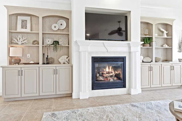 52 Tranquility Ln, Destin, FL 32541 - living area featuring a tiled fireplace, built in shelves, and crown molding