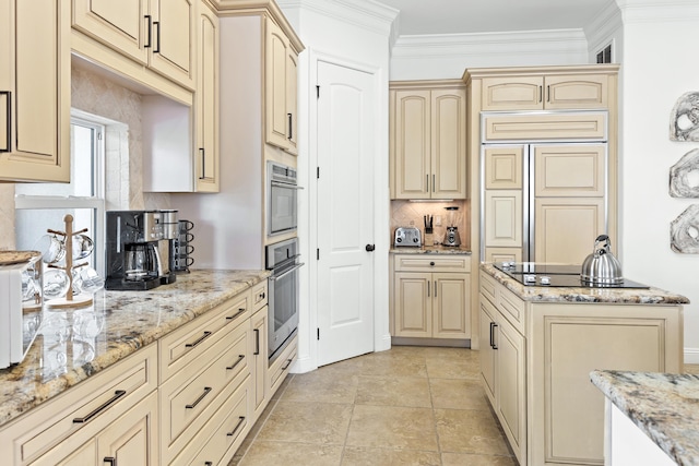 52 Tranquility Ln, Destin, FL 32541 - kitchen with cream cabinetry, light stone countertops, paneled refrigerator, and crown molding
