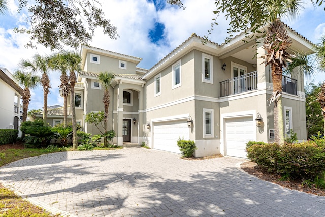 52 Tranquility Ln, Destin, FL 32541 - mediterranean / spanish home featuring a garage, stucco siding, and a balcony