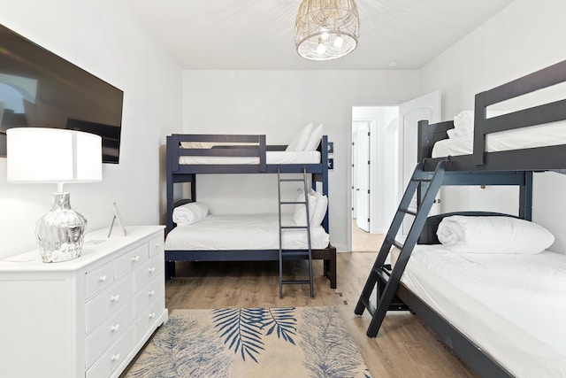 52 Tranquility Ln, Destin, FL 32541 - bedroom featuring light wood-style floors and a chandelier