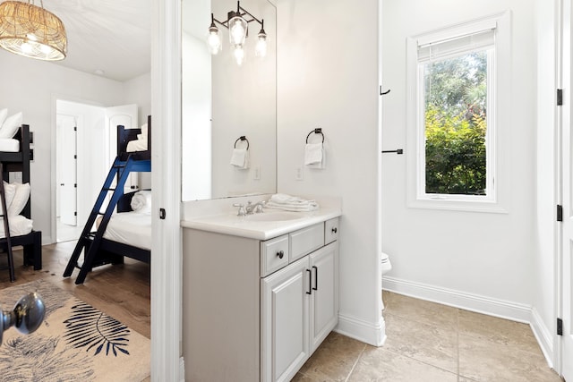 52 Tranquility Ln, Destin, FL 32541 - bathroom with vanity, toilet, ensuite bathroom, and baseboards