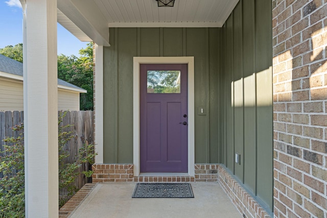 1511 23rd St, Niceville, FL 32578 - view of exterior entry featuring board and batten siding, brick siding, and a porch