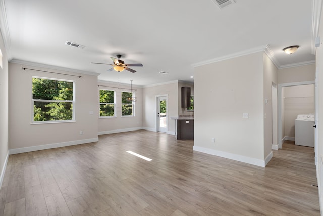1511 23rd St, Niceville, FL 32578 - unfurnished living room featuring washer / clothes dryer, a ceiling fan, baseboards, crown molding, and light wood-style floors