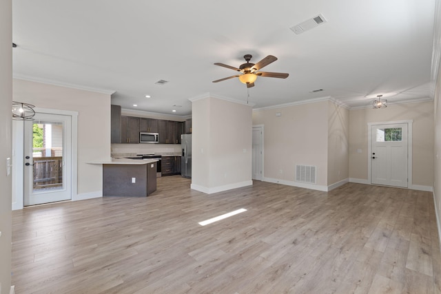 1511 23rd St, Niceville, FL 32578 - unfurnished living room with healthy amount of natural light, a ceiling fan, light wood-style flooring, ornamental molding, and baseboards