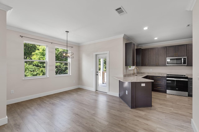 1511 23rd St, Niceville, FL 32578 - kitchen featuring appliances with stainless steel finishes, a sink, dark brown cabinets, a peninsula, and ornamental molding