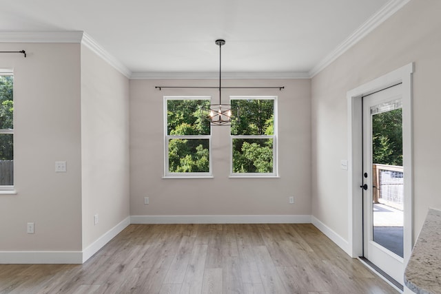 1511 23rd St, Niceville, FL 32578 - unfurnished dining area featuring light wood finished floors, a chandelier, crown molding, and baseboards