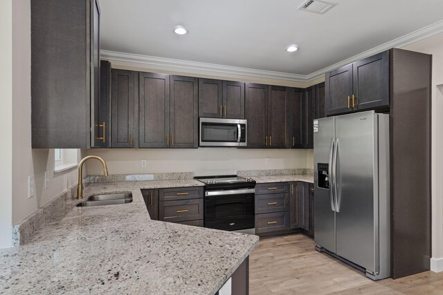 1511 23rd St, Niceville, FL 32578 - kitchen with stainless steel appliances, a sink, light stone countertops, crown molding, and recessed lighting