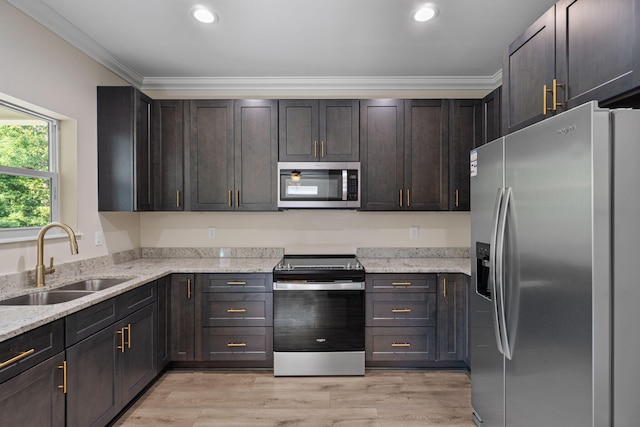 1511 23rd St, Niceville, FL 32578 - kitchen featuring appliances with stainless steel finishes, a sink, ornamental molding, light stone counters, and recessed lighting
