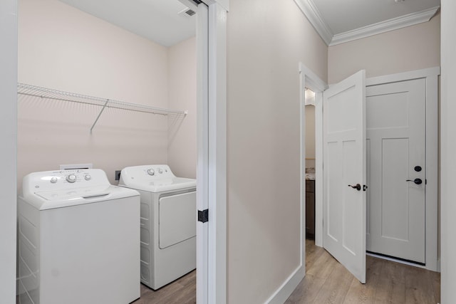 1511 23rd St, Niceville, FL 32578 - washroom featuring independent washer and dryer, ornamental molding, light wood finished floors, and baseboards