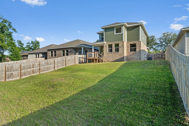 1511 23rd St, Niceville, FL 32578 - back of house featuring brick siding and central AC